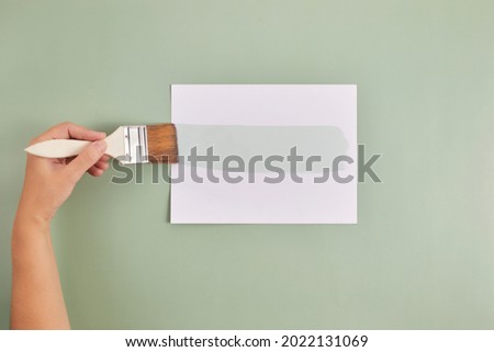 Happy Left Hander's Day. Left hand hold brush and writing text. Royalty-Free Stock Photo #2022131069