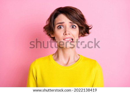 Portrait of attractive funny miserable nervous brown-haired girl biting lip isolated over pink pastel color background Royalty-Free Stock Photo #2022138419