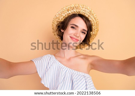 Photo of young attractive girl happy positive smile make selfie wear sunhat vacation isolated over beige color background