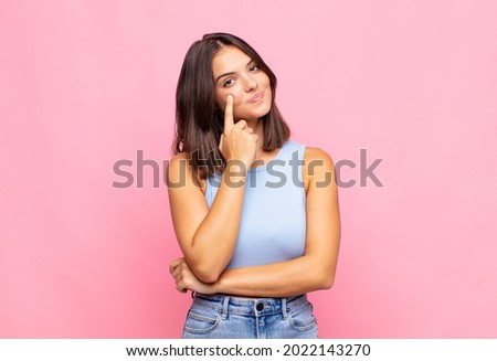 young pretty woman keeping an eye on you, not trusting, watching and staying alert and vigilant Royalty-Free Stock Photo #2022143270
