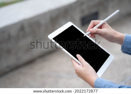 Close-up photo of female hands working with tablet computer. Woman using social network