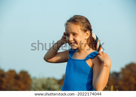 Picture of a little girl playing in nature on a summer day