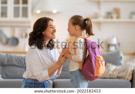 Happy family preparing for school. Little girl with mother. Royalty-Free Stock Photo #2022182453