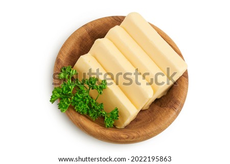 butter slices in wooden bowl isolated on white background with clipping path and full depth of field. Top view. Flat lay