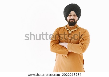 Young muslim man posing casually over white wall. Studio, isolated.