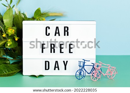 Toy bicycle and lightbox with text car free day. World bicycle day, environment protection idea