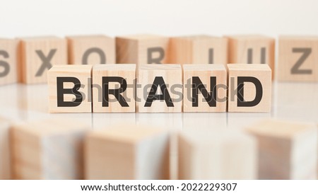 brand - wooden letters on the office desk, white background, business concept.