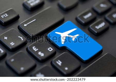 Close up of a blue return key airplane on computer keyboard Royalty-Free Stock Photo #202223479