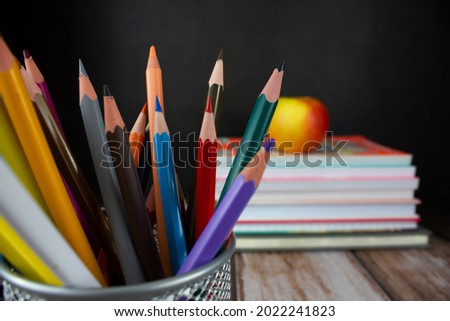 Pencils on a background of books and apples. Back to school concept. Background for design.