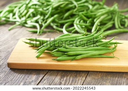 green beans handful on a cutting board, rustic style. Royalty-Free Stock Photo #2022245543