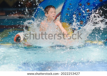 boy is in the water park.