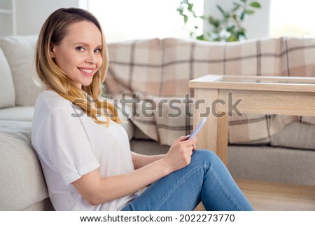 Profile side photo of young cheerful woman happy positive smile sit floor comfort use cellphone self-isolation indoors