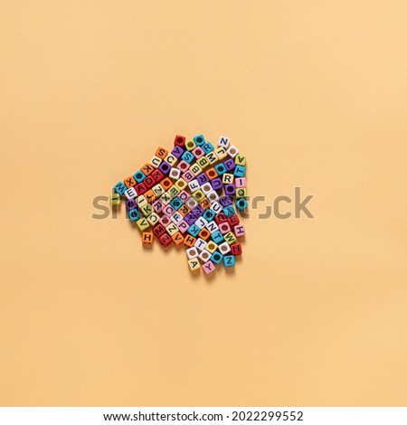 letter shaped beads Many people's hobbies are laid out on a yellow background, stacked together.