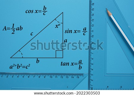 A picture of pencil, set square and right angle triangle drawing with formula on blue background. Geometry and trigonometry concept Royalty-Free Stock Photo #2022303503