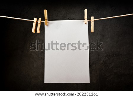 Blank note paper hanging on rope with clothes pins, copy space for your text or image or product placement.