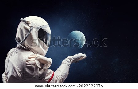 Spaceman and planets abstract theme Royalty-Free Stock Photo #2022322076