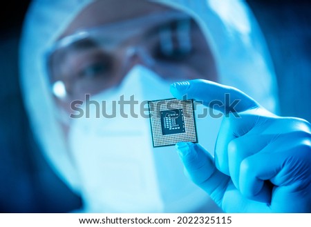 The scientist works in a modern scientific laboratory for the research and development of microelectronics and processors. Microprocessor manufacturing worker uses computer technology and equipment. Royalty-Free Stock Photo #2022325115