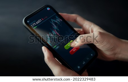 Cryptocurrency Investment Concept. Person Using Mobile Phone to Buy and Sell Bitcoin via Online Exchange Platform. Blockchain,Fintech Technology. Innovation of Financial Investment. Closeup shot Royalty-Free Stock Photo #2022329483