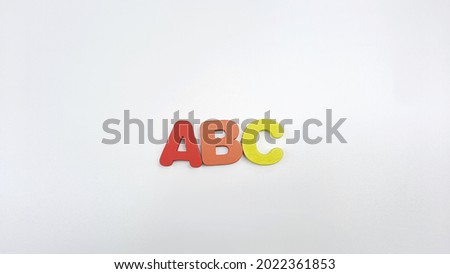 ABC- Children's alphabet learning set on isolated white background.  Wooden ABC alphabet for montessori learning. ABCDE Spelling with colorful letters