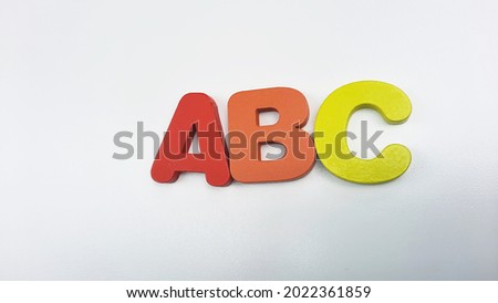 ABC- Children's alphabet learning set on isolated white background.  Wooden ABC alphabet for montessori learning. ABCDE Spelling with colorful letters