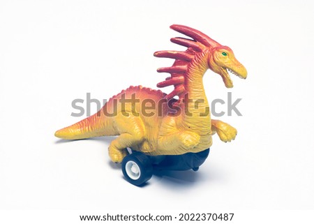 A dinosaur toy with wheels