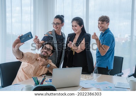 At Break time to relaxed business  team take photo selfie photo in mini heart signal at office show by happiness and successful in work. Royalty-Free Stock Photo #2022386303