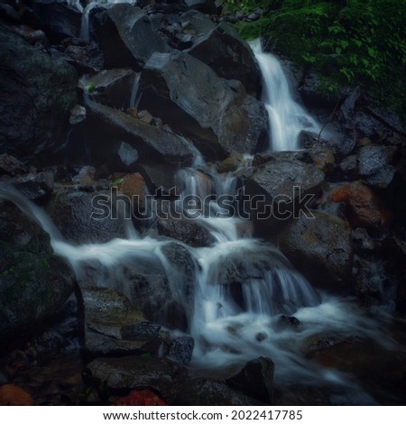 This picture is of small and beutiful waterfall with cool dark eye pleasing effect and vivid colours.