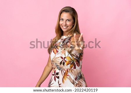 Middle age brazilian woman over isolated background smiling and showing victory sign