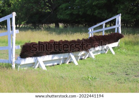 Cross-country wooden fence obstacle for an equestrian cross country event  on empty race track