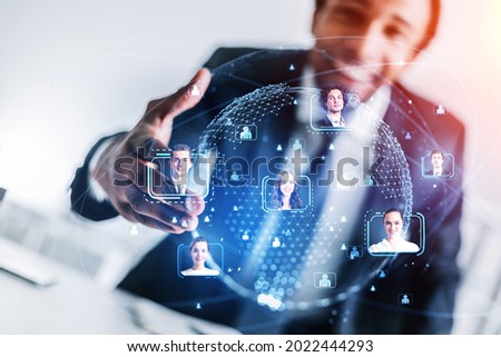 African American businessman holding out the hand for handshake as a concept of recruitment process for the international project. Social media people icons and hologram of worldwide globe Royalty-Free Stock Photo #2022444293
