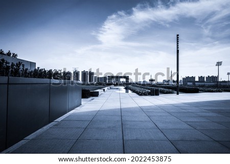 Empty square with sky and building as background.