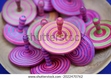 Colored wooden spinning tops, handcrafted. Selective focus.