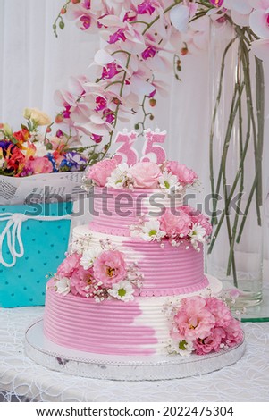 Festive three-story cake for 35th birthday woman Royalty-Free Stock Photo #2022475304