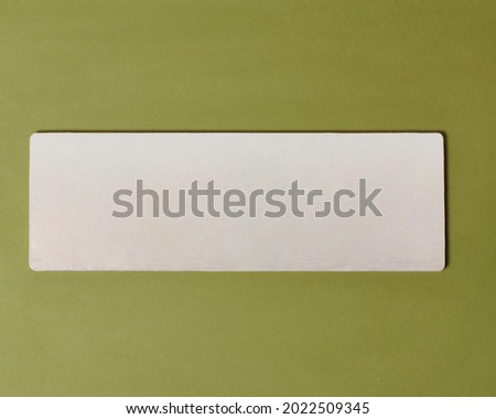 Blank gray board mock up made of mdf board for house sign, blank space for your advertisement, blank board with green background, to make it easier for you to find address, blank board for name sign