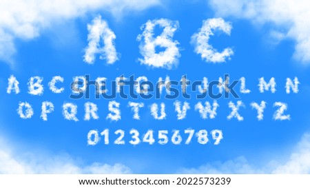 Clouds alphabet and numbers in the blue sky Royalty-Free Stock Photo #2022573239