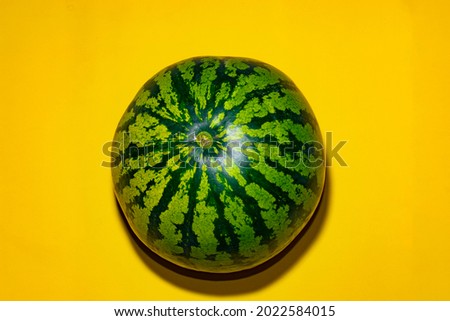 Watermelon on a yellow background. Isolated watermelon