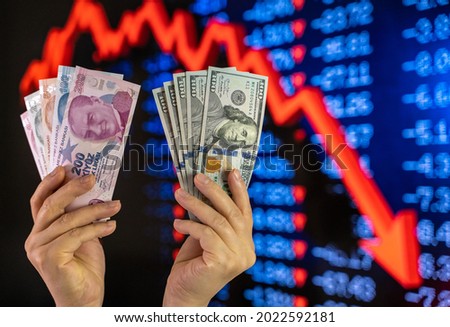 Turkish Lira and US Dollar Exchange. Stock market crash screen representation in the background. Royalty-Free Stock Photo #2022592181