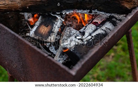 burning coals lying in an old iron barbecue. High quality photo