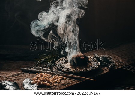 Charcoal burning with incense, incense resin, rosemary, 
laurel, lavender on a rustic wooden table,smudging, energetic cleansing .Sahumar
 Royalty-Free Stock Photo #2022609167