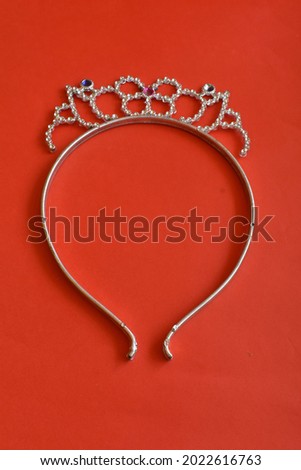 a child's headband on a red background
