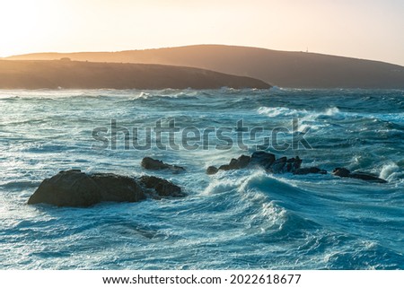 Amazing power of waves crashing against the rocks during sunset. Big ocean wave breaking the shore. The beauty of nature concept. Beautiful sea landscape. Wallpaper, background.	