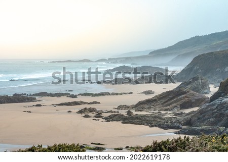 Wild beautiful seascape of Galicia, Spain during sunset. Lonely beach. Summer travel concept. Freedom, relax. Beauty of nature.