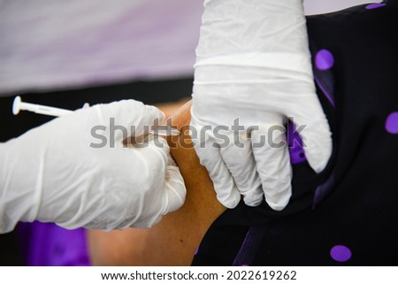 A person being administered the COVID-19 vaccine