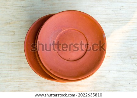 Clay coasters on a wooden table background.