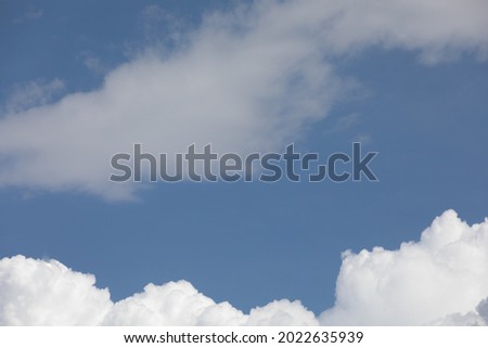 fluffy white clouds against the bright sky