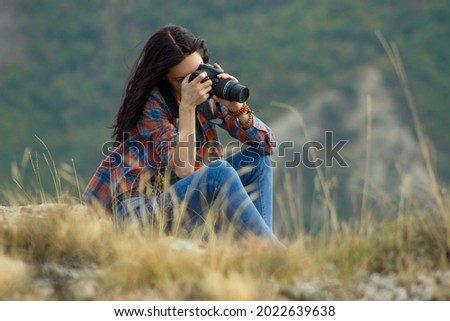 Dark haired girl taking a photo