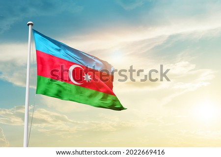 Azerbaijan national flag waving in beautiful clouds. Royalty-Free Stock Photo #2022669416