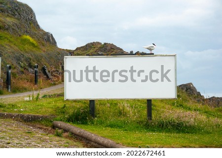 Big white empty billboard mockup with nature landscape background. South Wales, UK.
