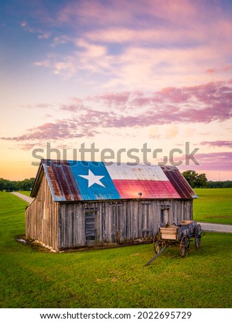 Old barn painted with Texas State flag Royalty-Free Stock Photo #2022695729