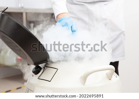 Liquid nitrogen cryogenic tank at life sciences laboratory: Steam of nitrogen created from liquid nitrogen exposed to ambient temperatures Royalty-Free Stock Photo #2022695891